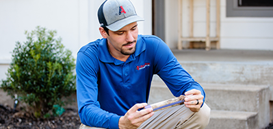 pest expert checking sentricon station