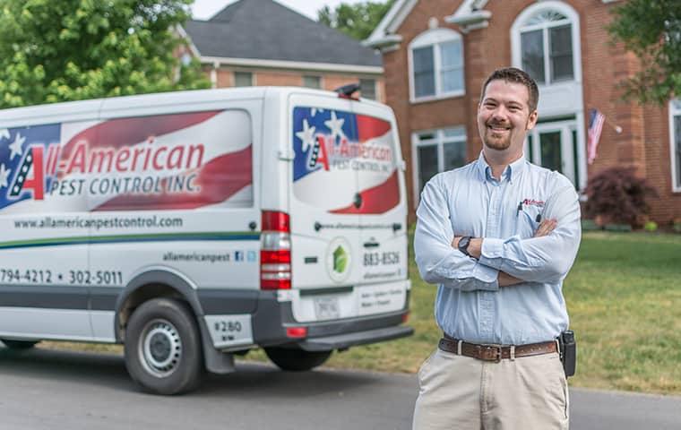 Learn More About Home Pest Control In Spring Hill TN all american tech standing in front of service vehicle outside of clients home in spring hill tennessee