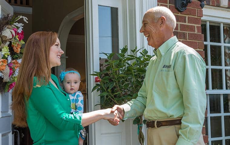 nashville pest control technician greeting homeowner