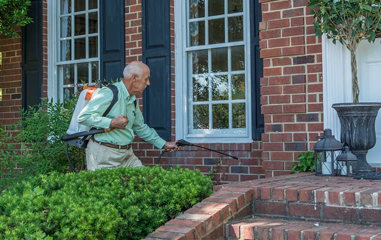 all american tech providing an exterior treatment to reduce spiders outside of arrington tennessee home