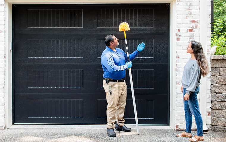 nashville pest control technician performing cobweb removal