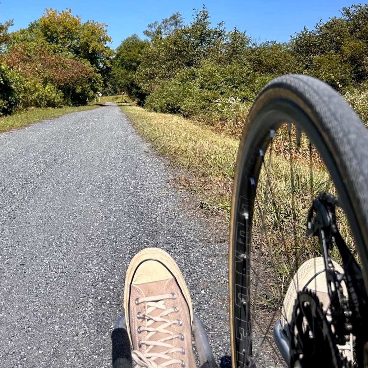 Edie's view from bike - front wheel with her feet and path