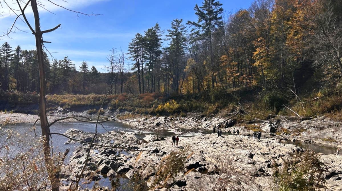 People enjoying the rocks on a warm fall day