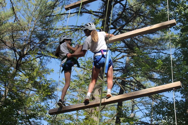 Girls enjoy the ropes course at Camp Tapawingo, Maine.