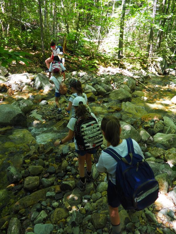 Girls from Camp Tapawingo head out on a hiking trail in Maine.