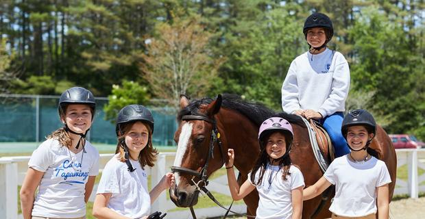 Campers at Camp Tapawingo, Maine, take a break from horseback riding.