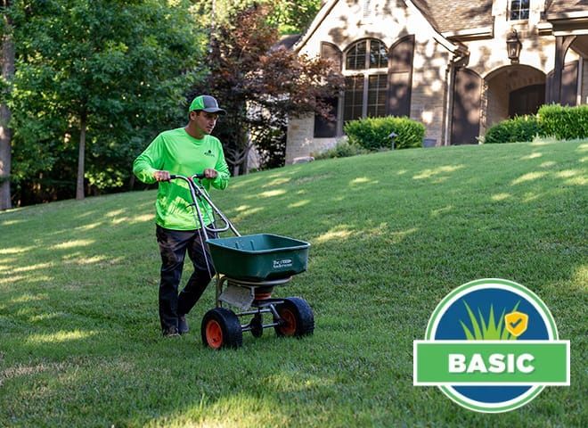 lawn care specialist overseeding a lawn