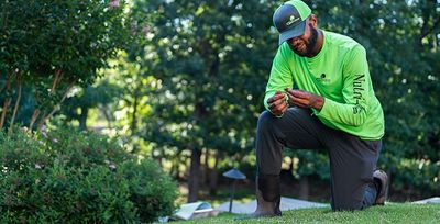 tulsa lawn care pro inspecting grass