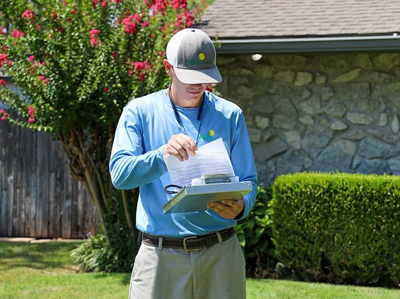 exterminator inspecting tulsa property