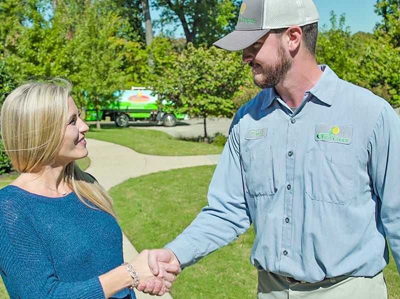 lawn care specialist greeting tulsa homeowner
